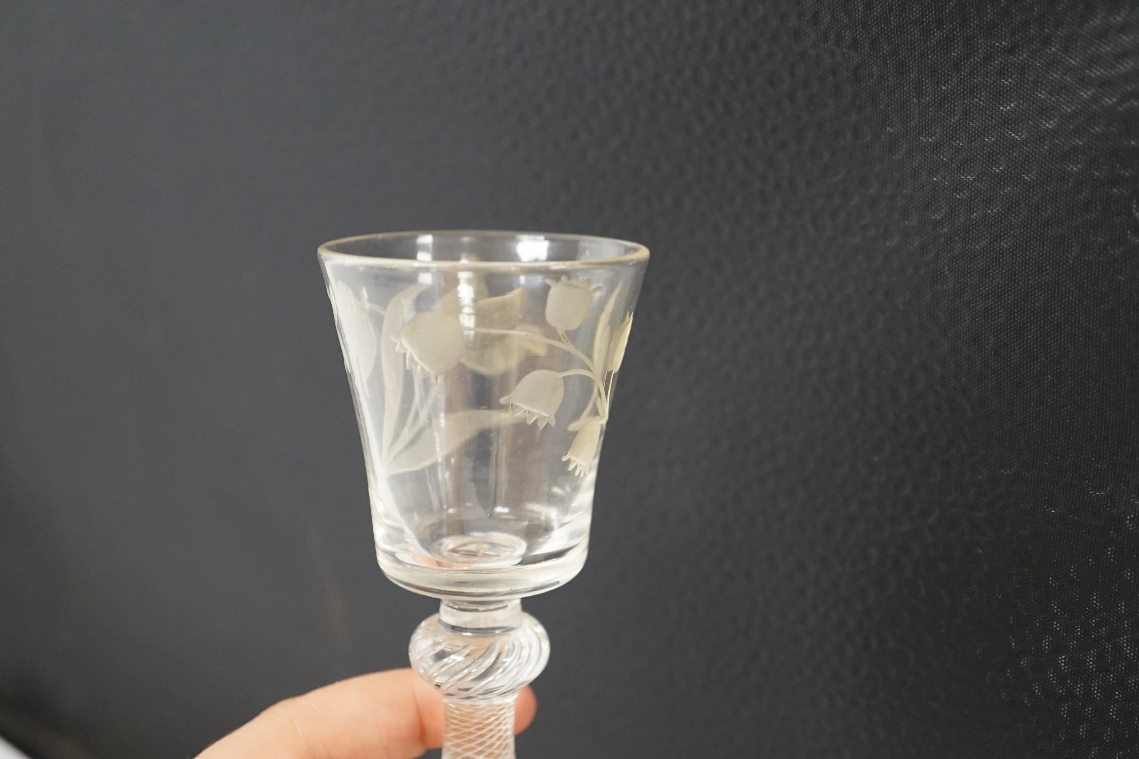 A mid 18th century air twist stem cordial glass with later engraved decoration, 15.5cm high. Condition - fair